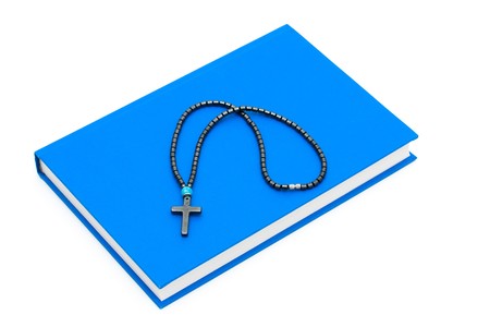 A cross sitting on a  book isolated on a white background, Religion in schools
