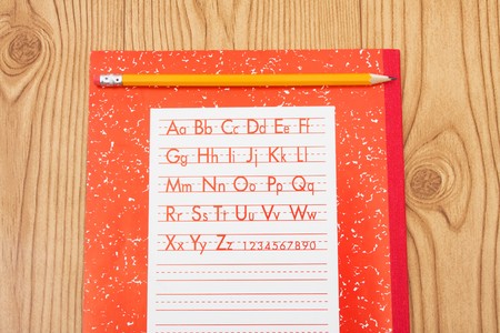 A pencil on a workbook, school work