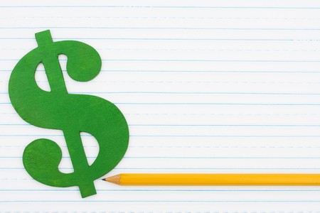A dollar sign with a pencil on a lined paper background, Cost of educationの写真素材