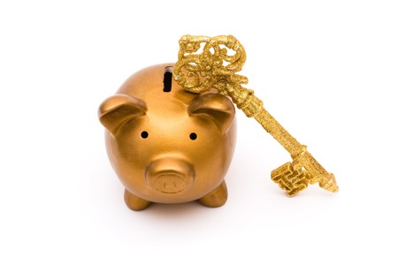 A golden piggy bank with a gold retro key, Keys to financial successの写真素材