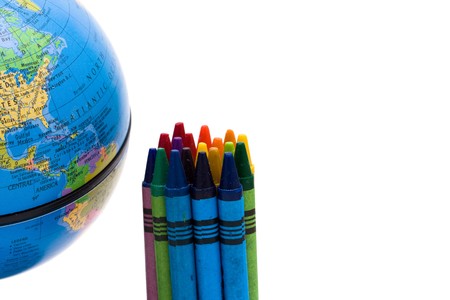 Globe with a bunch of crayons isolated over white, International Educationの写真素材
