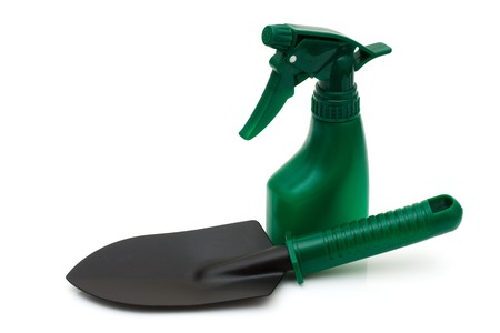 A green spray bottle and spade isolated on a white background, gardening toolsの写真素材