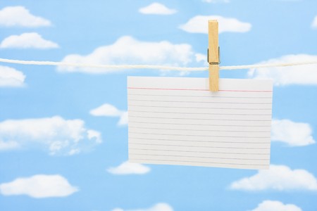 A blank index card hanging on a clothesline with copy space for your text の写真素材