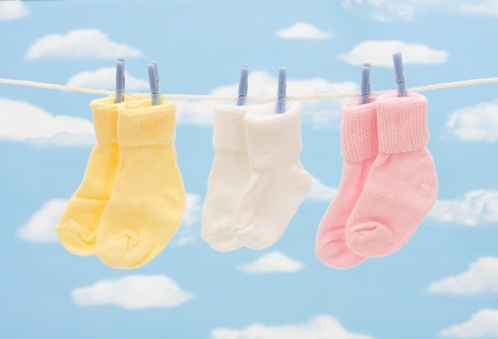 Baby socks hanging on a clothesline with copy spaceの写真素材