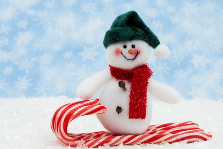 snowman on a candy cane sled with snow, Snowman having funの写真素材