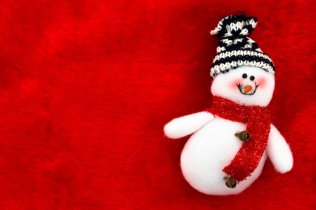 A snowman  on a red textured background, Christmas timeの写真素材