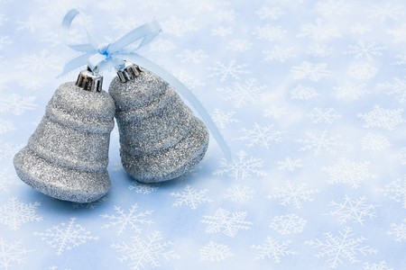 Two silver bells on a blue snowflake background, Christmas Timeの写真素材