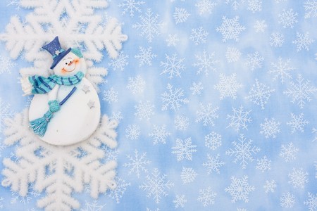 A snowflake and a snowman on a blue snowflake background, Christmas Timeの写真素材