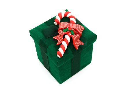 A green christmas present with a candy cane on a white background, christmas presentの写真素材