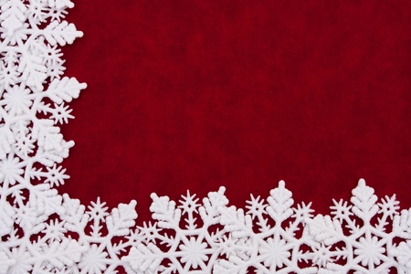 A white snowflake border on a red background, winter timeの写真素材