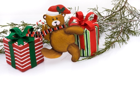 A teddy bear with christmas presents on a white backgroundの写真素材