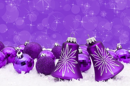 Purple christmas balls on a snow and purple background, christmas timeの写真素材