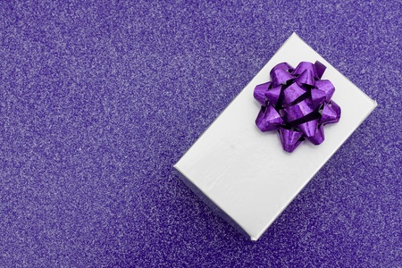  A silver present with bow on purple background, holiday givingの写真素材