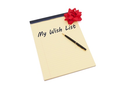 Blank yellow lined notepad with copy-space and words My Wish List and a pen, Making your Wish Listの写真素材