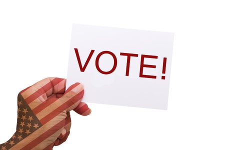 Female hands holding a card with word vote with the American flag on them isolated on whiteの写真素材