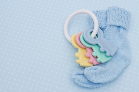 Baby soother and socks on a blue polka dots background with copy space for you message, Blue Baby Backgroundの写真素材