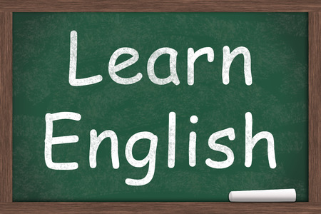 Learning English, Learn English written on a chalkboard with a piece of white chalkの写真素材