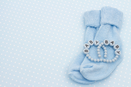 Baby Blue Background with Baby Socks and Bracelets with copy space for your messageの写真素材