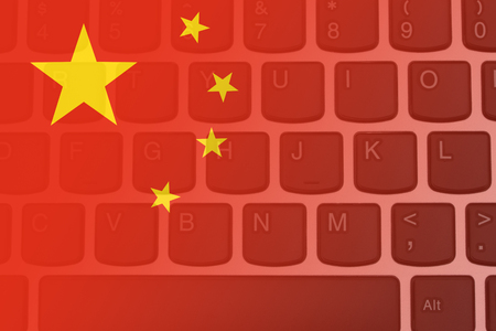 Black and silver computer keyboard with the Chinese flagの写真素材