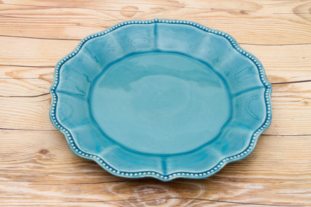 Empty Teal Plate on a weathered wood backgroundの写真素材