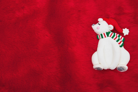 Red Plush Fur and Christmas Bear Christmas Background with copy space for your messageの写真素材