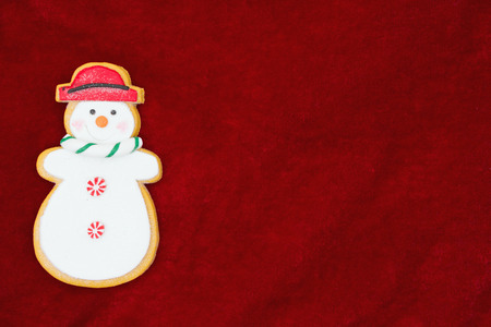 Red plush fabric with a snowman background with copy-space for messageの写真素材