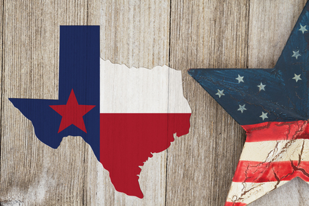 Map of Texas with the Texas Flag colors with a star on weathered wood background