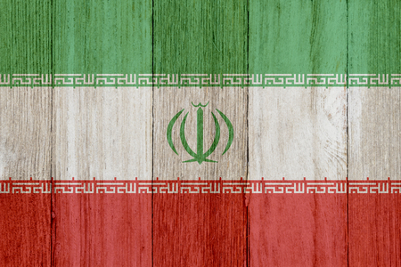 A rustic old Iranian flag on weathered wood for a backgroundの写真素材