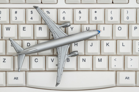 Booking your flight on the Internet, A close-up of a keyboard with an aiplaneの写真素材