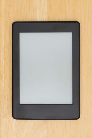 A blank e-reader on a desk that you can use as a mock up for your messageの写真素材