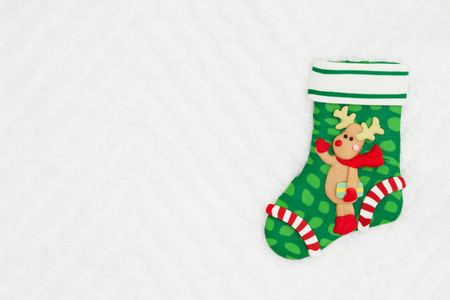 Christmas stocking with a reindeer on white chevron textured fabric  that you can use as a mock up for your message for Christmasの写真素材
