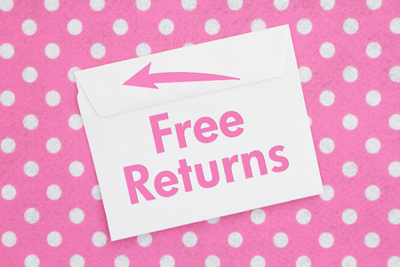 Free returns message on a white envelope on pink and white polka dot fabric