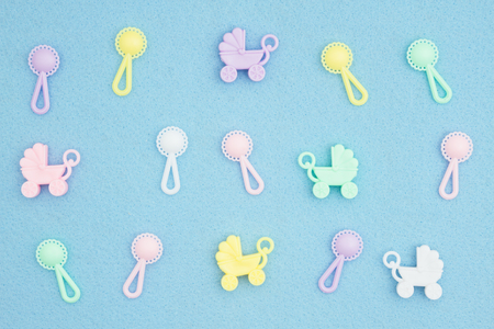 Baby strollers and rattles on an blue textured material  for your babyの写真素材