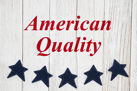 American quality text with blue stars on weathered whitewash textured woodの写真素材
