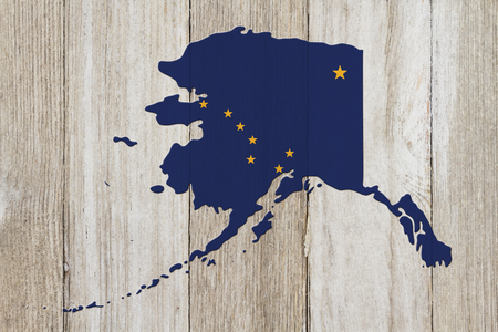 Map of Alaska in the Alaska flag colors on weathered woodの写真素材