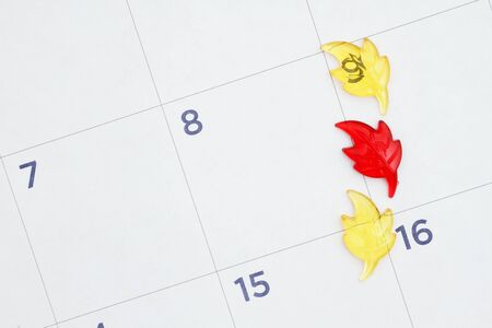 Fall leaves on a monthly calendar with copy space for your fall season appointmentsの写真素材