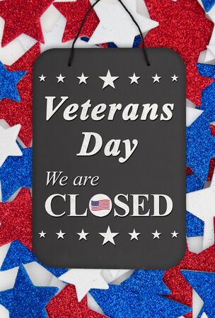 Veterans Day closed sign message on chalkboard with red, white and blue glitter starsの写真素材