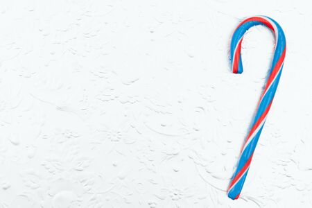 Red, white and blue candy cane on a silver  with copy space for your messageの写真素材