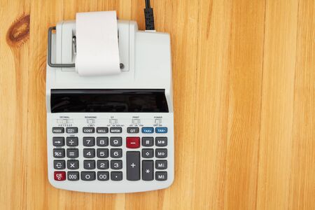 Electric calculator with a display on wooden desk with copy spaceの写真素材