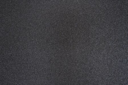 Black glitter paper background with copy-space for your message and useful for textures of text and...