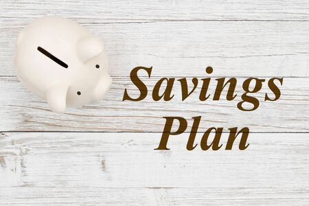 Your Saving Plan with a piggy bank on weathered whitewash wood の写真素材