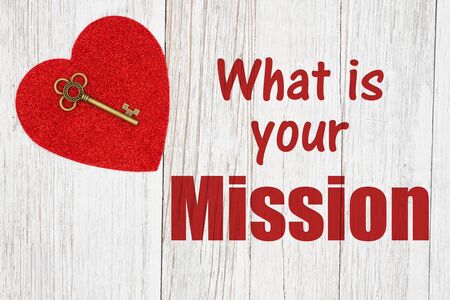 What is your mission text with a skeleton key on a red heart on weathered whitewash wood の写真素材
