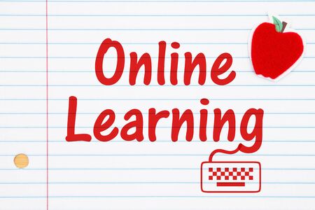 Online Learning words with a red apple and keyboard icon on lined paper