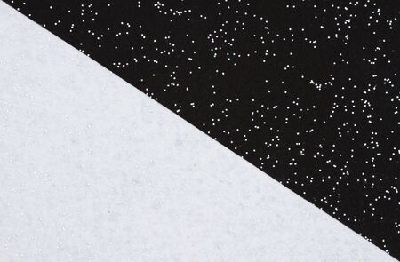 Black and white sparkle felt material background that is divided on the diagonalの写真素材