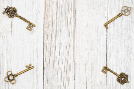 Skeleton keys on weathered whitewash wood background with grain texture with copy space for your security or lock messageの写真素材