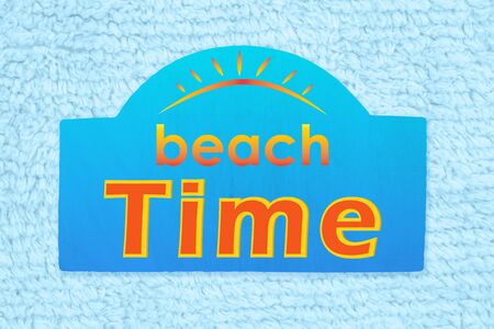 Beach Time type message on blue wood sign on pale blue plush lined fabricの写真素材