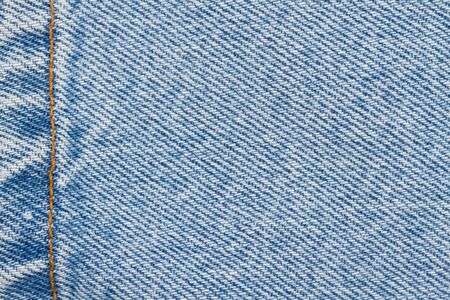 Blue jeans denim material with stiches background with copy space for message or use as a textureの写真素材