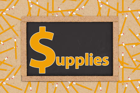 Dollar sign symbol for word supplies on grunge chalkboard with pencils and paperの写真素材