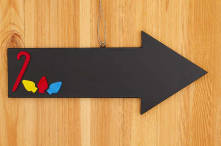 Christmas blank hanging arrow chalkboard sign with a candy cane sign on wood with copy space for your xmas or holiday messageの写真素材