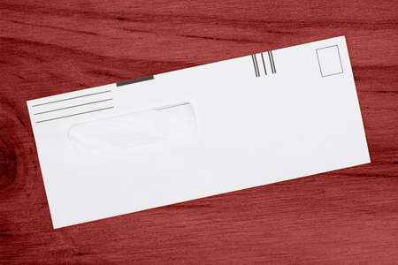 Blank business envelope on a wood desk mockup for your message